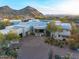 Luxury desert home with a paved driveway, multiple garages, and beautiful desert landscaping at 10029 E Calle De Las Brisas --, Scottsdale, AZ 85255