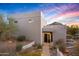Modern home exterior with desert landscaping, neutral tones, and a striking entry against a colorful sky at 10029 E Calle De Las Brisas --, Scottsdale, AZ 85255