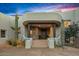 Inviting home featuring a stone accent wall, dark wood pillars, a desert landscape and a covered front entrance at 10029 E Calle De Las Brisas --, Scottsdale, AZ 85255