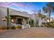 Desert home featuring an exposed aggregate driveway, xeriscaping, and covered entrance at 10029 E Calle De Las Brisas --, Scottsdale, AZ 85255