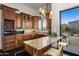 Well-lit kitchen featuring custom cabinetry, a granite-topped island, and modern pendant lighting at 10029 E Calle De Las Brisas --, Scottsdale, AZ 85255