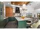 Modern kitchen features green cabinets, marble countertops, and stainless steel appliances with open floor plan at 10029 E Calle De Las Brisas --, Scottsdale, AZ 85255
