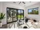 Cozy living room features plush seating, a modern rug, and large windows with views of the landscaped yard at 10029 E Calle De Las Brisas --, Scottsdale, AZ 85255