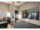 Living room showcasing hardwood floors, a comfortable sofa, and a view of the backyard basketball court at 10029 E Calle De Las Brisas --, Scottsdale, AZ 85255