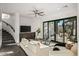 Bright living room with a neutral palette, modern staircase, and expansive sliding glass doors at 10029 E Calle De Las Brisas --, Scottsdale, AZ 85255