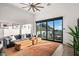 Bright living room featuring a comfortable sofa, a patterned rug, and sliding glass doors offering mountain views at 10029 E Calle De Las Brisas --, Scottsdale, AZ 85255