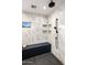 Stylish marble shower with a rain shower head, built-in niche shelving, and a sleek black bench at 10029 E Calle De Las Brisas --, Scottsdale, AZ 85255