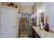 Tiled bathroom featuring glass-enclosed shower and granite vanity at 10250 E Morning Star Dr, Scottsdale, AZ 85255