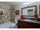Cozy bathroom with a tub, tiled wall, and vanity with a dark wood finish at 10250 E Morning Star Dr, Scottsdale, AZ 85255