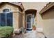Inviting home entrance featuring a decorative front door, potted flowers, and manicured landscaping at 10250 E Morning Star Dr, Scottsdale, AZ 85255