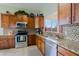 Well-equipped kitchen featuring stainless steel appliances, granite countertops, and custom cabinetry at 10250 E Morning Star Dr, Scottsdale, AZ 85255