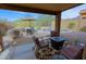 Inviting covered patio with comfortable seating, a table and view of the sparkling pool and well maintained backyard at 10250 E Morning Star Dr, Scottsdale, AZ 85255