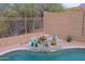 Close-up of the pool's waterfall feature, surrounded by lush desert plants, rock accents and a desert view at 10250 E Morning Star Dr, Scottsdale, AZ 85255