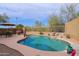 Inviting backyard pool with a water feature, rock accents, desert landscaping, and patio seating for relaxing at 10250 E Morning Star Dr, Scottsdale, AZ 85255