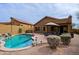 A beautiful backyard pool with mature desert landscaping, rock accents, patio furniture, and lush desert scape at 10250 E Morning Star Dr, Scottsdale, AZ 85255