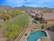Backyard with a pool and a rock waterfall feature surrounded by desert landscaping at 10250 E Morning Star Dr, Scottsdale, AZ 85255