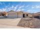 Well-maintained, single-story home featuring a three-car garage, desert landscaping, and a covered front porch at 10623 W Alex Ave, Peoria, AZ 85382