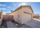 Attached two car garage with paved driveway and view of backyard fence at 10623 W Alex Ave, Peoria, AZ 85382