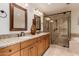 Stylish bathroom features a double sink vanity with granite countertop and a glass-enclosed shower at 11175 N 109Th Pl, Scottsdale, AZ 85259