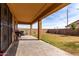 Covered back patio with a view of the fenced in backyard at 11851 W Alvarado Rd, Avondale, AZ 85392