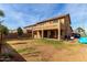 Large backyard with a grass area and patio with outdoor seating at 11851 W Alvarado Rd, Avondale, AZ 85392