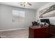 Bedroom with wood-look tile flooring, ceiling fan and a large window at 11851 W Alvarado Rd, Avondale, AZ 85392