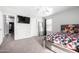 Comfortable bedroom with a large bed, carpet floors, and a mounted TV at 11851 W Alvarado Rd, Avondale, AZ 85392