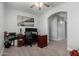 Bedroom with wood-look tile flooring, ceiling fan and an arched doorway at 11851 W Alvarado Rd, Avondale, AZ 85392