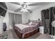 A comfy bedroom features a ceiling fan, soft carpet and a coordinated color scheme at 11851 W Alvarado Rd, Avondale, AZ 85392