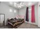 This cozy bedroom has an adorable decorative mirror, plush carpets, and unique decor at 11851 W Alvarado Rd, Avondale, AZ 85392