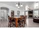 Open-concept dining room with views of the living room fireplace and a built-in pantry at 11851 W Alvarado Rd, Avondale, AZ 85392