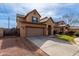 Inviting two-story home with a tile roof, mature landscaping and a two-car garage at 11851 W Alvarado Rd, Avondale, AZ 85392