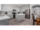 Modern kitchen features gray cabinets, stainless steel appliances, and a center island at 11851 W Alvarado Rd, Avondale, AZ 85392