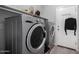 Laundry room features modern front loading washer and dryer at 11851 W Alvarado Rd, Avondale, AZ 85392