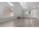 Bright living room with neutral walls, high ceilings, and wood-look tile floors at 11851 W Alvarado Rd, Avondale, AZ 85392