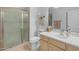 Bathroom featuring shower with glass door, wood vanity, faucet sink, and tile floor at 12050 N Panorama Dr # 107, Fountain Hills, AZ 85268
