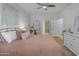 Bright bedroom features modern decor, soft lighting, and a view into the ensuite bathroom at 12050 N Panorama Dr # 107, Fountain Hills, AZ 85268