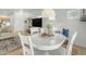 Bright dining area with a white round table and chairs, and a view of the entrance area at 12050 N Panorama Dr # 107, Fountain Hills, AZ 85268