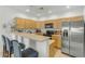 Modern kitchen featuring stainless steel appliances, wooden cabinets, breakfast bar, and tile flooring at 12050 N Panorama Dr # 107, Fountain Hills, AZ 85268