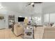 Open-concept living area featuring tile floors, comfortable sofas, and a dining area near the windows at 12050 N Panorama Dr # 107, Fountain Hills, AZ 85268