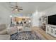 Bright living room with tile floors, ceiling fan, comfortable seating, and open layout to the dining area at 12050 N Panorama Dr # 107, Fountain Hills, AZ 85268