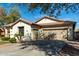 Exterior view of a well-maintained home with a desert landscape and a spacious three-car garage at 1236 E Nightingale Ln, Gilbert, AZ 85298