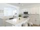 Modern kitchen with white cabinetry, stainless steel appliances and island with bar stool seating at 1236 E Nightingale Ln, Gilbert, AZ 85298