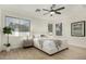 Well-lit main bedroom with a ceiling fan, multiple windows, and luxury vinyl plank flooring at 1236 E Nightingale Ln, Gilbert, AZ 85298