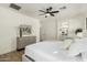 Spacious main bedroom with a ceiling fan, multiple windows, and luxury vinyl plank flooring at 1236 E Nightingale Ln, Gilbert, AZ 85298