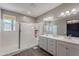 Bright bathroom featuring a glass-enclosed shower, wood-look floors, and a dual sink vanity with lots of counter space at 1255 N Arizona Ave # 1246, Chandler, AZ 85225