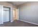 Neutral bedroom with a closet and an open door to another room at 1255 N Arizona Ave # 1246, Chandler, AZ 85225