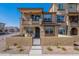 Beautiful two-story townhome showcasing a charming front patio, attractive desert landscaping and inviting curb appeal at 1255 N Arizona Ave # 1246, Chandler, AZ 85225