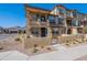 Charming two-story townhome featuring a cozy front patio with stylish wrought iron gate and beautiful desert landscaping at 1255 N Arizona Ave # 1246, Chandler, AZ 85225