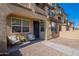 Inviting front porch showcasing seating area and wreath on the front door of this lovely townhome at 1255 N Arizona Ave # 1246, Chandler, AZ 85225
